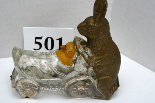 Collectors call this scarce candy container Rabbit Pushing Chick in Shell Cart. The paint is original. Image courtesy Old Barn Auction.